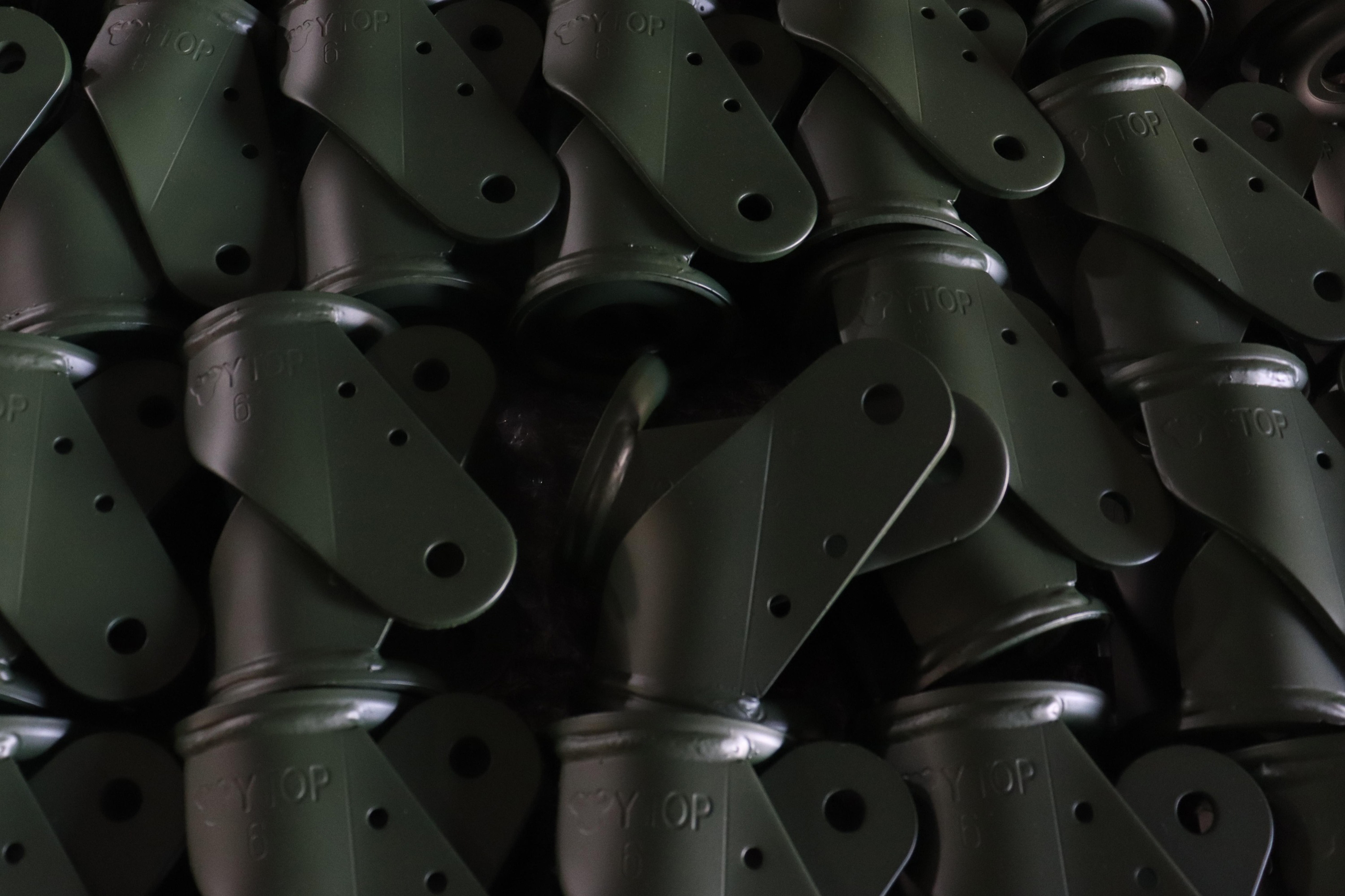 Green caster bracket blanks ready for assembly